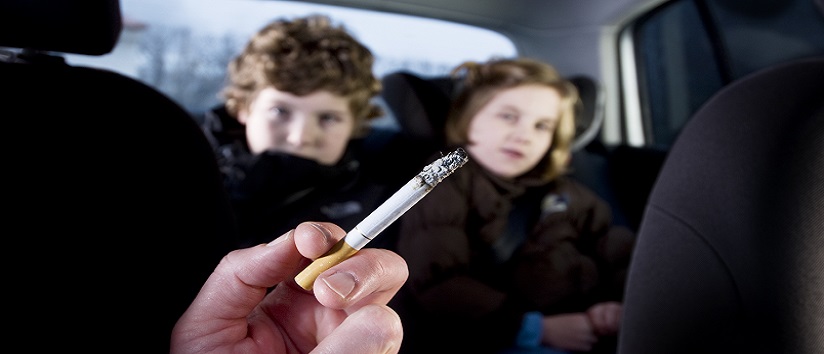Person smoking in car with children