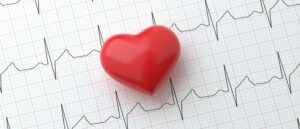Toy heart over a ECG scan