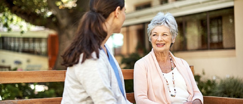 social care, nurse talking to older patient