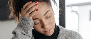 Woman with a headache, Long Covid symptoms