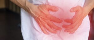 Man holding his stomach in pain, constipation, IBS