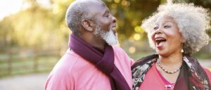 older man and woman laughing together