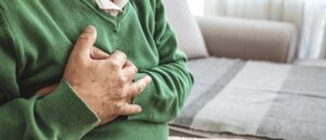 oldre man with hand over heart, heart disease, cardiovascular disease, aortic valve stenosis