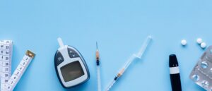 A blood sugar monitoring kit on a blue background