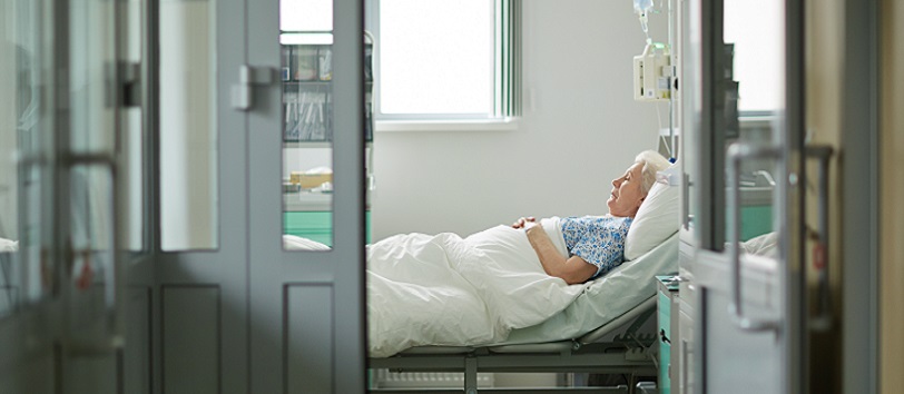 Older woman lying in hospital bed, sepsis patient