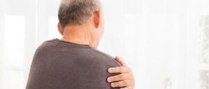 Man holding his shoulder
