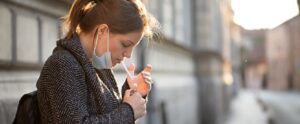 Woman smoking with a face mask on