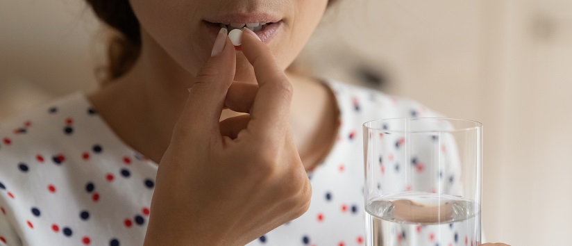 Woman taking Vitamin D supplement