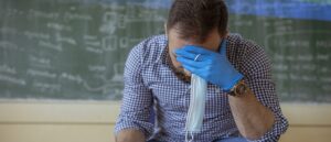 stressed teacher wearing Covid mask