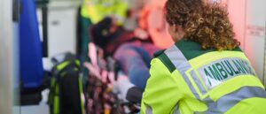 Ambulance crew moving patient into hospital