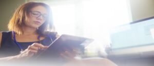 Female doctor sat at her desk using her digital tablet for an array of different scenarios