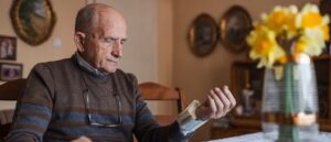 Mature man measuring his blood pressure at home