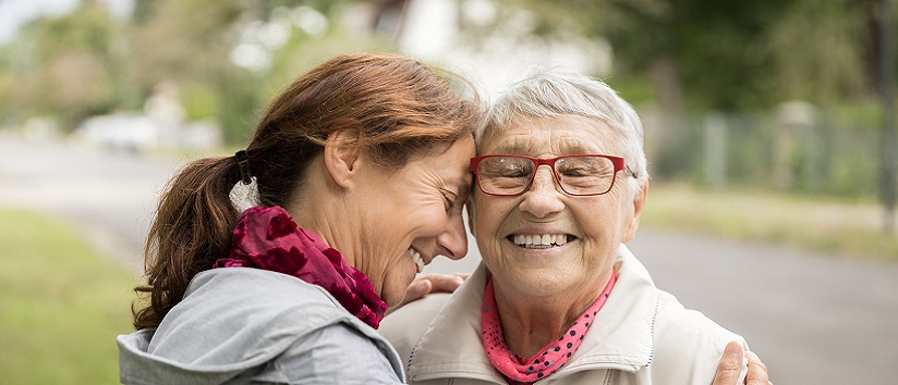Older woman having a hug with her carer