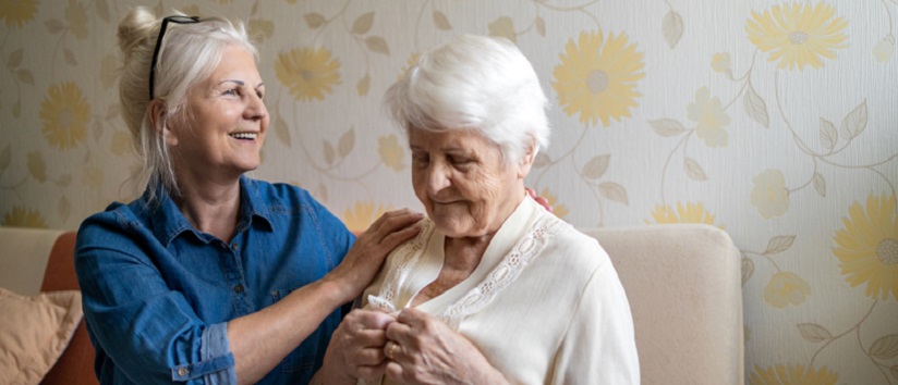 Woman helping senior woman, dementia care