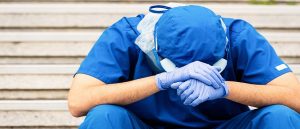 Doctors looking sad with head in hands