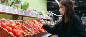 Person wearing face mask in shop, Covid-19