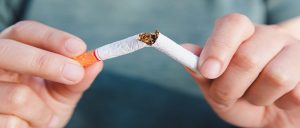 Someone snapping a cigarette in two, smoking