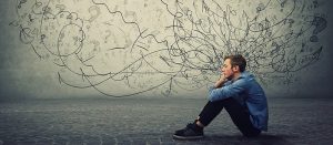 Man sitting on floor looking stressed