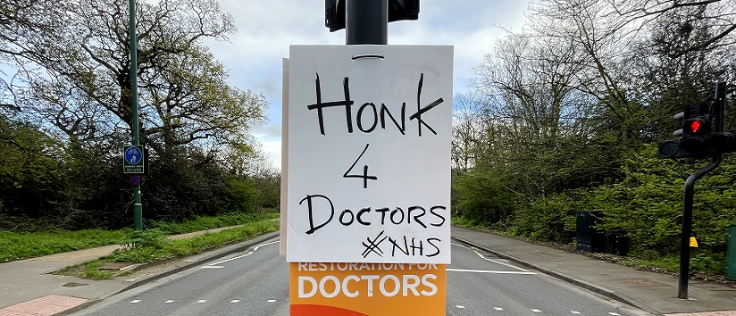 Street sign in support of doctor strikes
