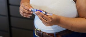 Woman holding diabetes medication