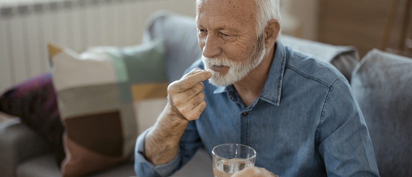 Older person taking vitamin b12 tablet