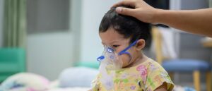 Asian baby was sick as Respiratory Syncytial Virus (RSV) in kid hospital. Thai little girl having inhaler containing medicine for stop coughing and disease flu.