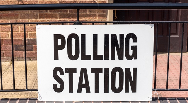 A 'Polling Station' sign outside village hall during a UK election.