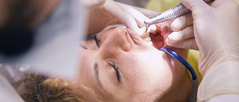Dentist performing dental services