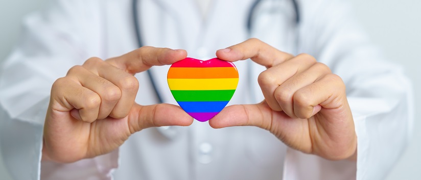 Doctor holding a LGBTQ+ sign
