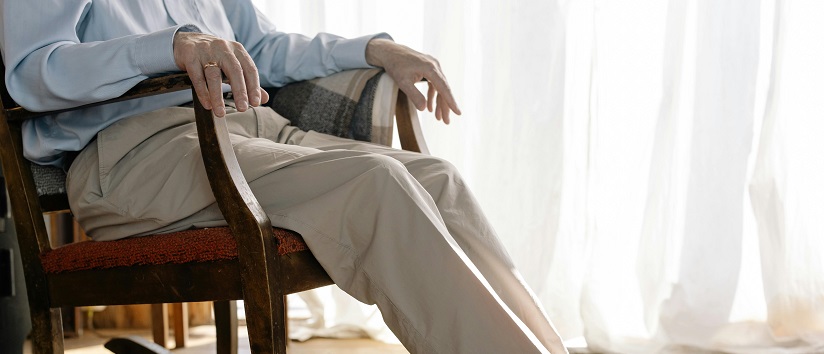 Parkinson's disease, older man sat in chair